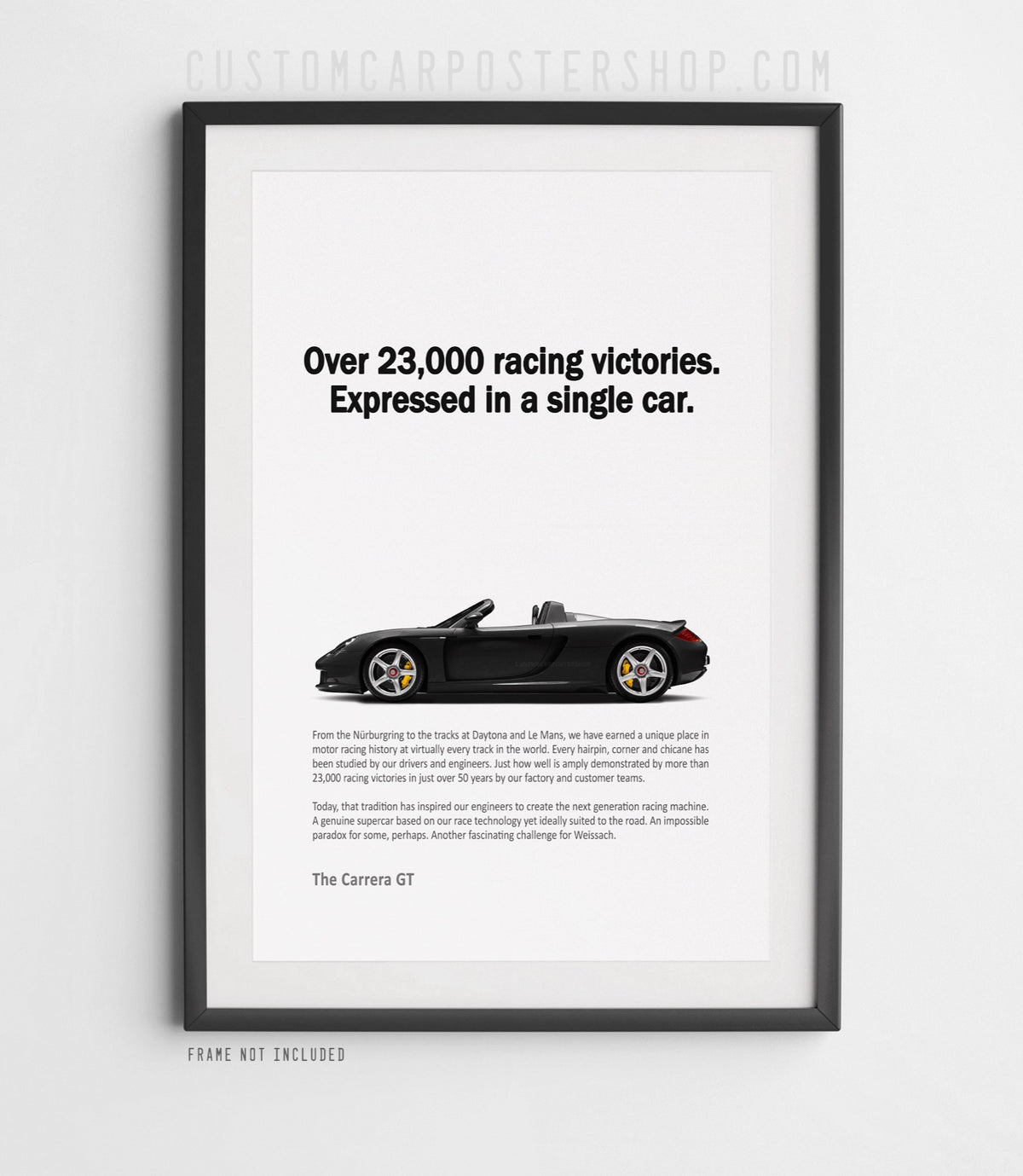 Remastered Porsche Carrera GT “Over 23,000 racing victories” print ad poster featuring a black open-top supercar in side profile.