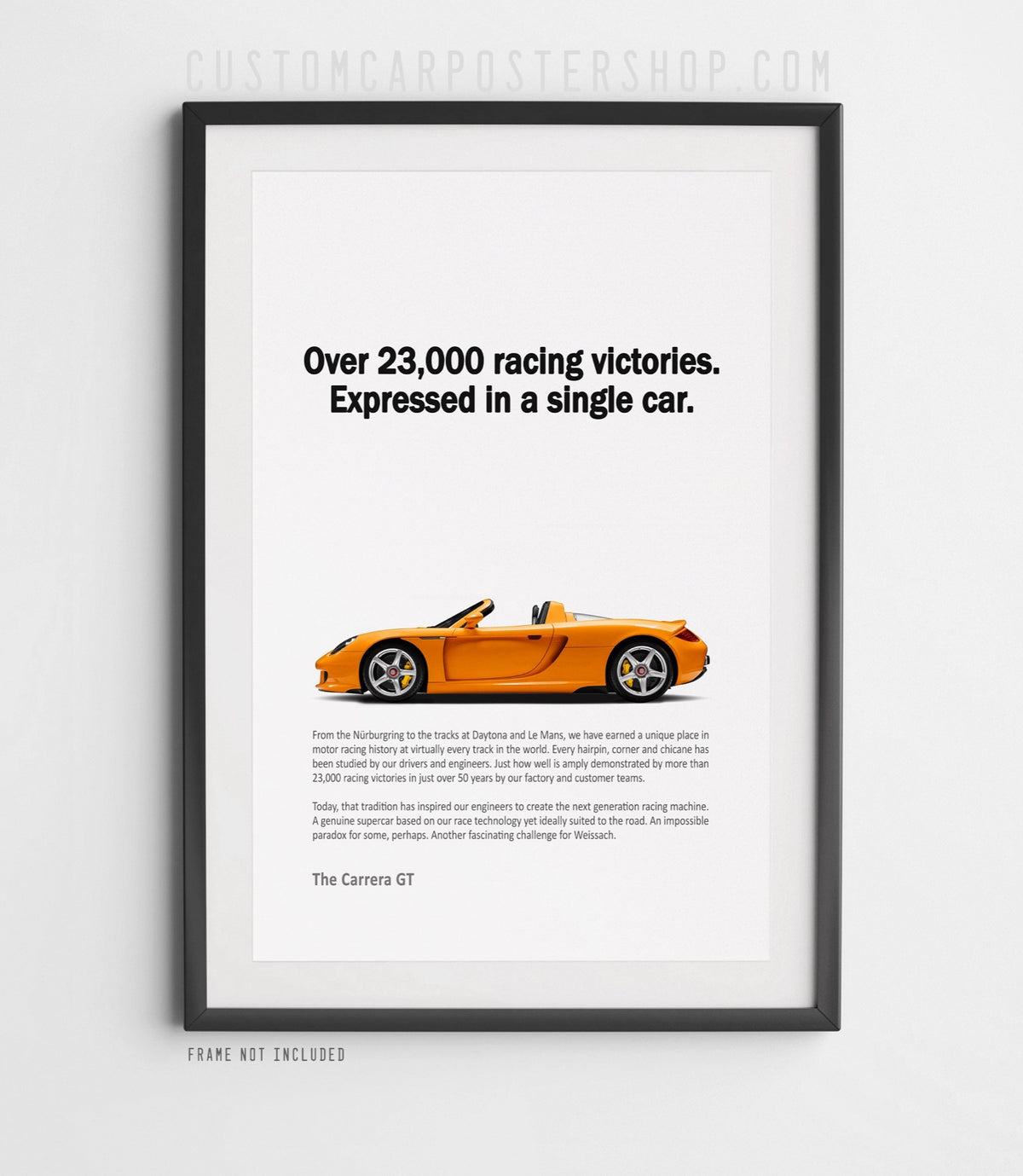 Remastered Porsche Carrera GT “Over 23,000 racing victories” print ad poster featuring an orange open-top supercar in side profile.