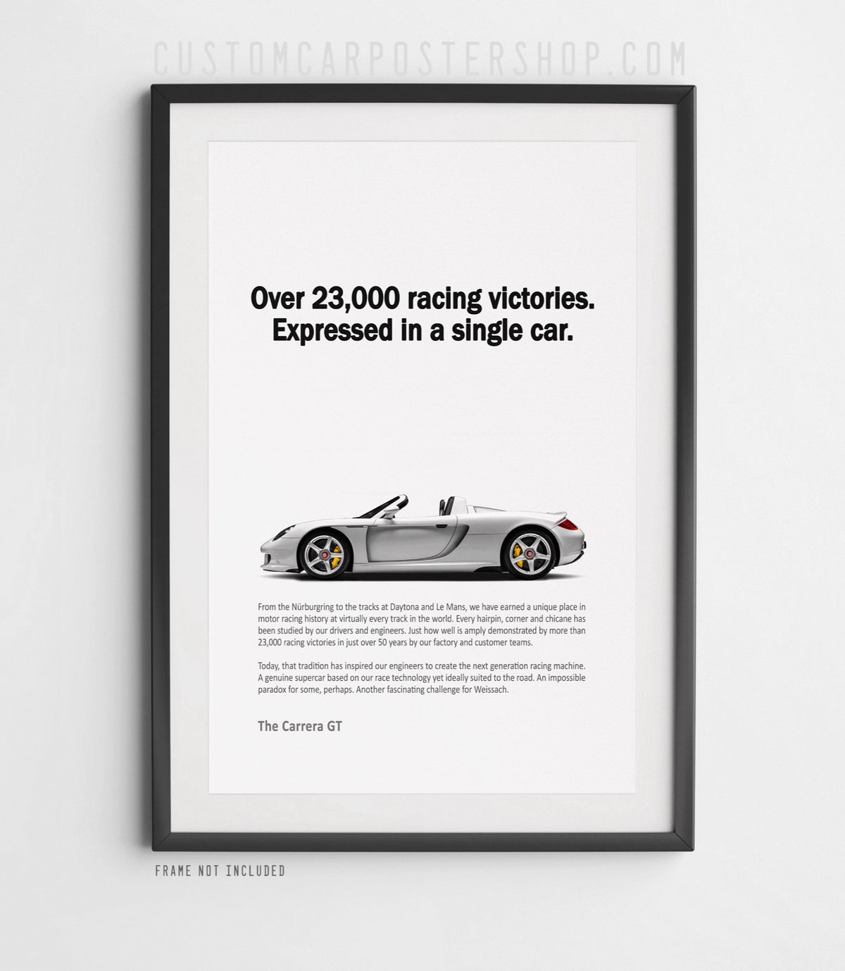 Remastered Porsche Carrera GT “Over 23,000 racing victories” print ad poster featuring a silver open-top supercar in side profile.
