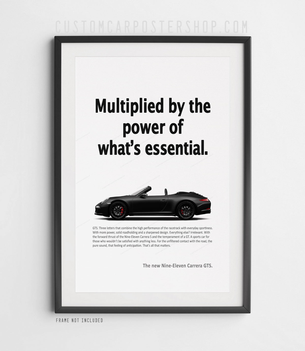 Black Porsche 911 Carrera GTS Cabriolet in side view on the remastered ‘Power of What’s Essential’ advertisement poster.