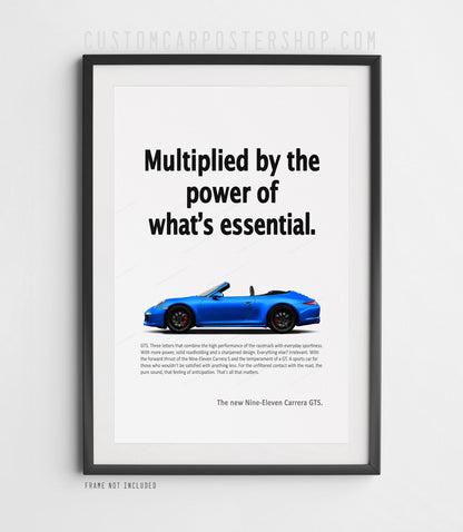 Blue Porsche 911 Carrera GTS Cabriolet (991.1), roof down, in side profile on the ‘Power of What’s Essential’ retro print ad, shown in a black frame mock-up.