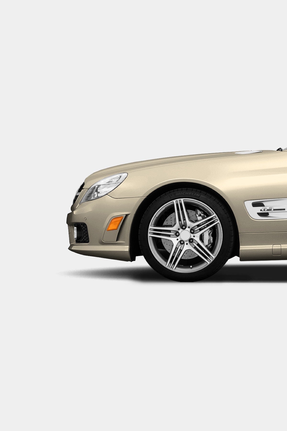 Close-up detail of the remastered Mercedes-Benz SL 63 AMG print ad showing the gold R230 front end and AMG multi-spoke wheel.